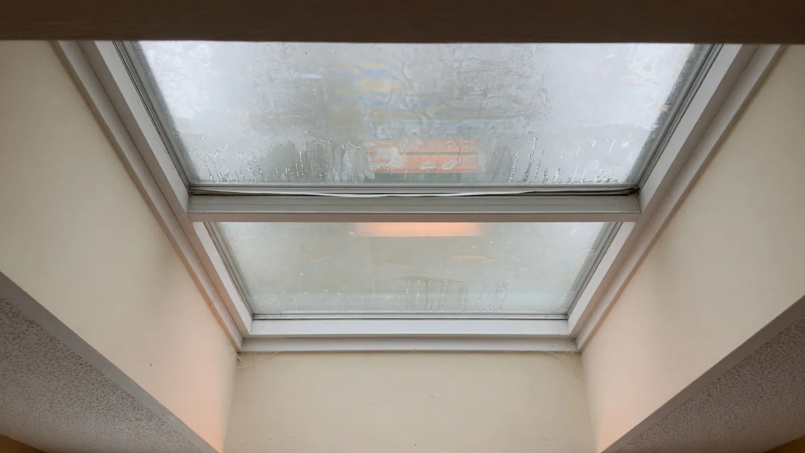 Milky haze trapped between the two panes of a residential skylight