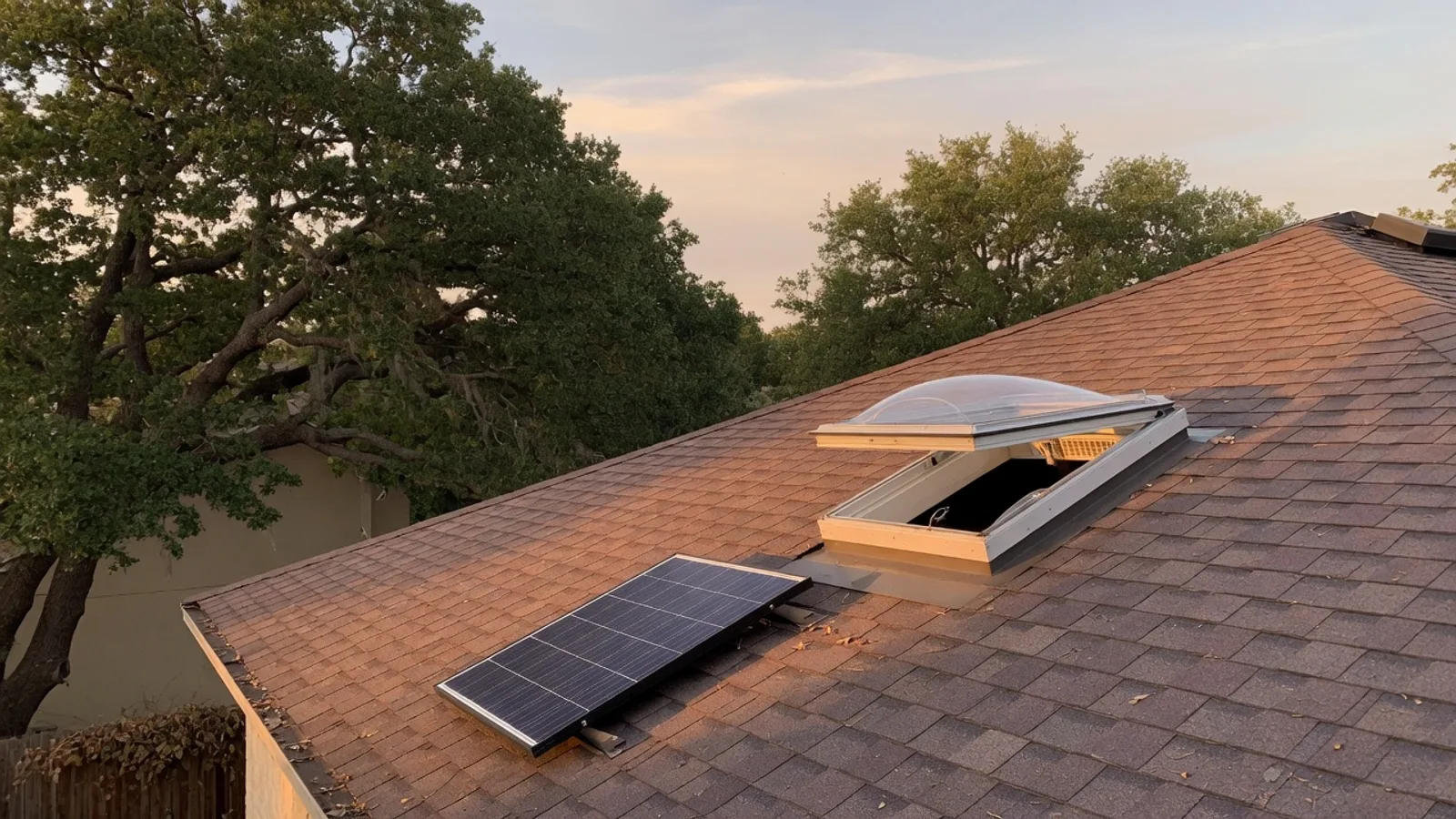 Vented residential skylight on an Austin shingle roof with a small solar panel nearby